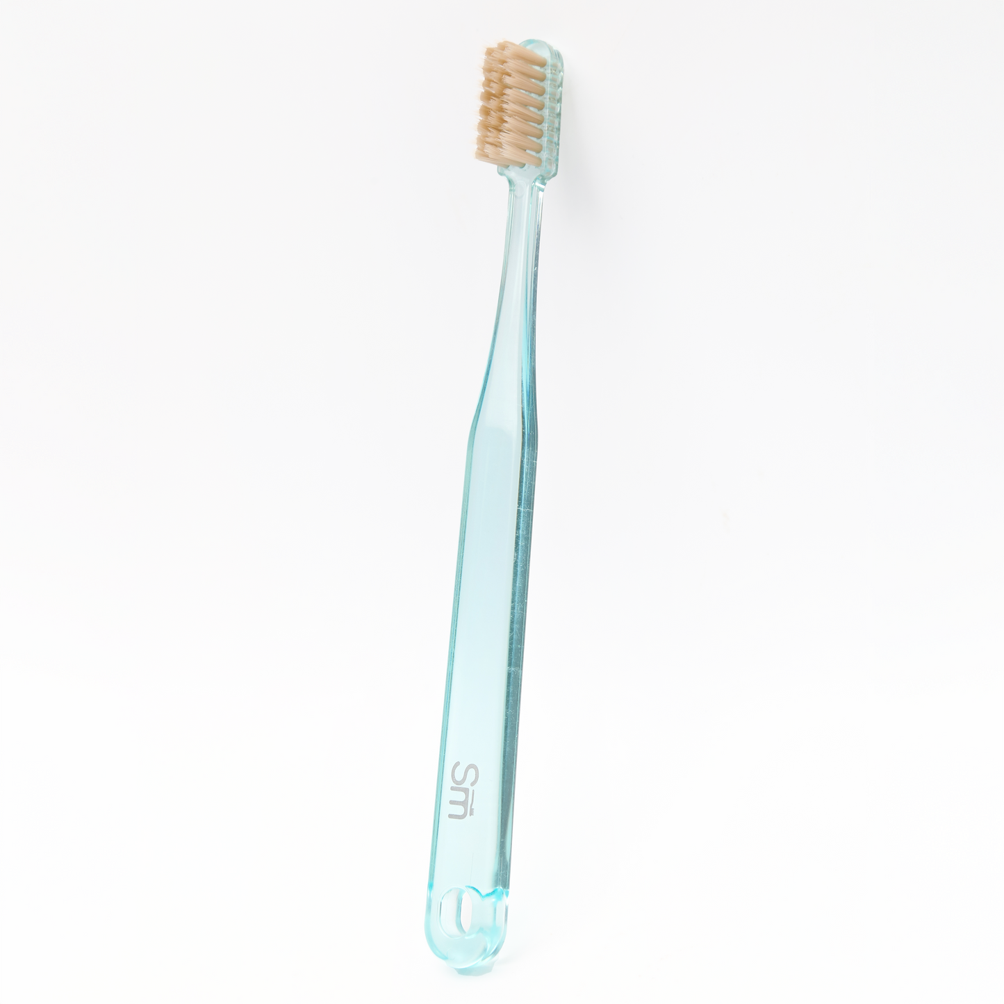 Light blue toothbrush with brown bristles on a white background