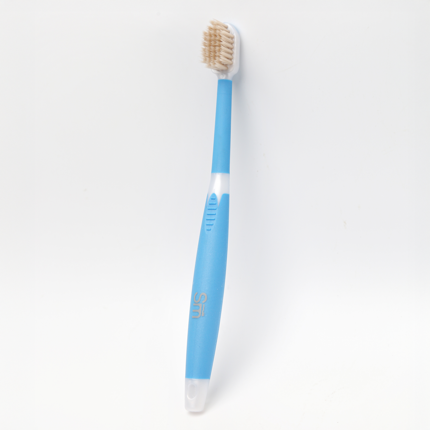 Blue toothbrush with a white handle on a light gray background
