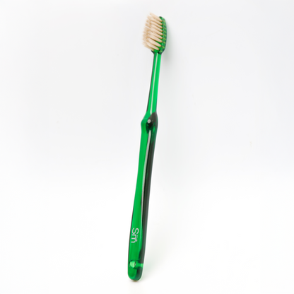 Green toothbrush on a white background