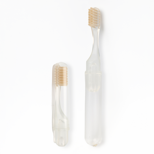 Transparent toothbrush with beige bristles on a white background